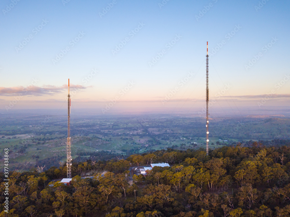 Aerial view of two large antennae on the top of a hill Aerial view of two large antennae on the top of a hill