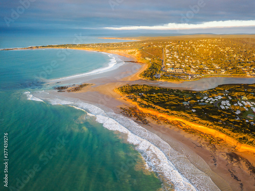Aerial view of waves breaking along the beaches at the mouth of the Anglesea River photo
