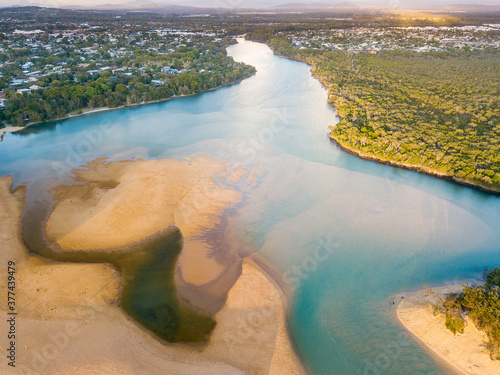 Aerial view of a widening river with sandbars