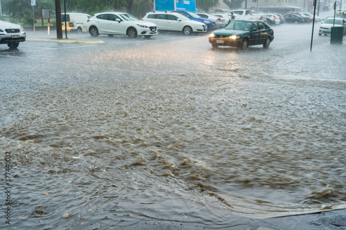 Flooding rain crossing a city street