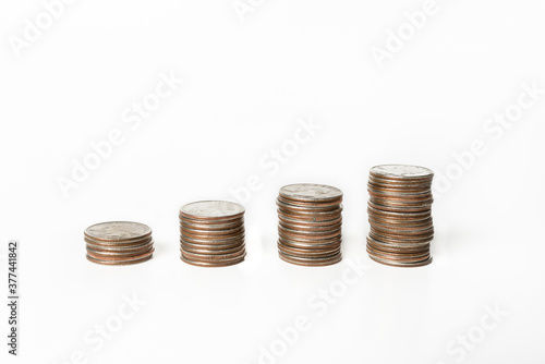 Stacks of US quarters in ascending order on a white background 