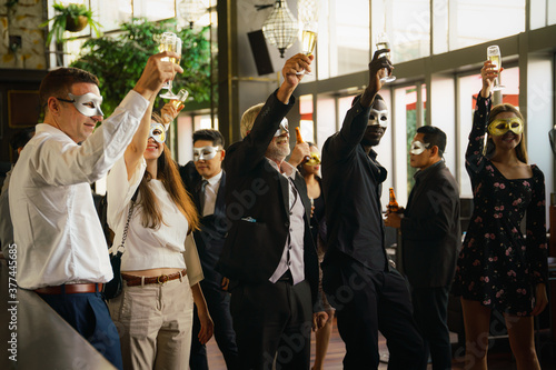 businesspeople toasting in business mask party at club