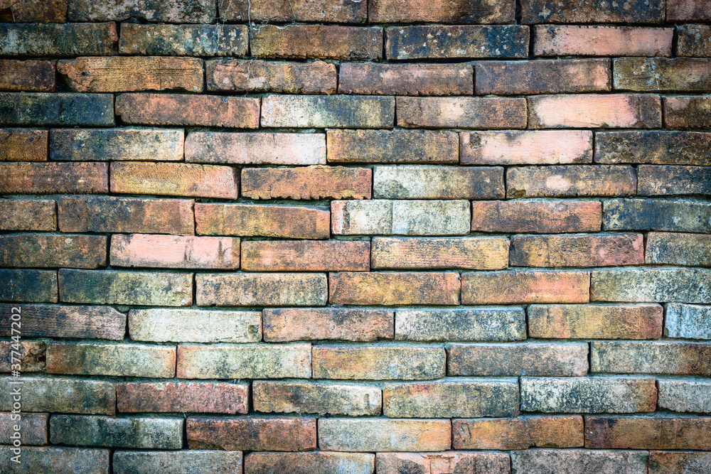 Obraz premium Old wall background with stained aged bricks.