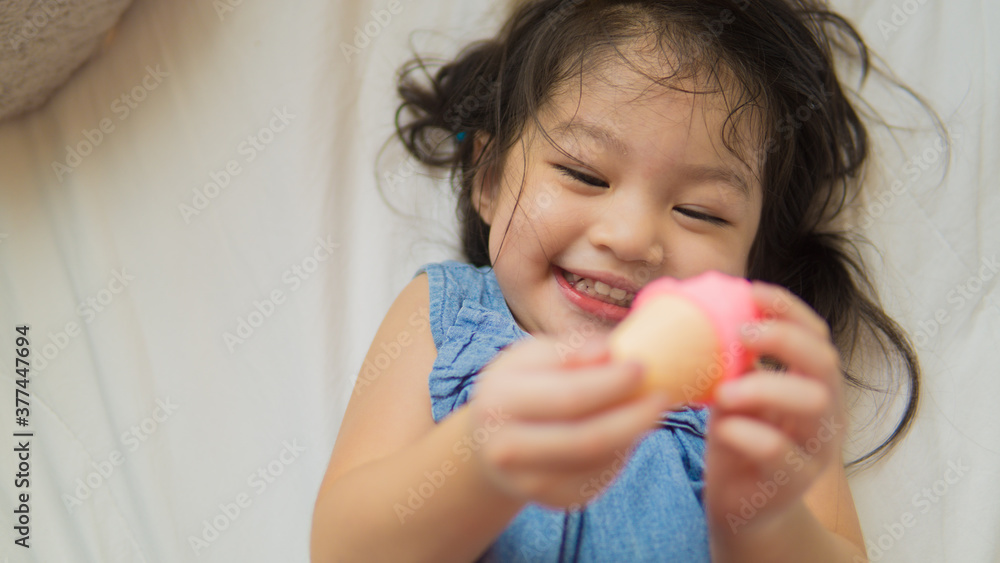 Cute Asian toddler girl playing ice-cream toy Cute Asian toddler girl playing ice-cream toy