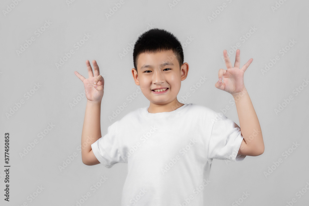 Asian boys studio shot portrait on gray background Asian boys studio shot portrait on gray background