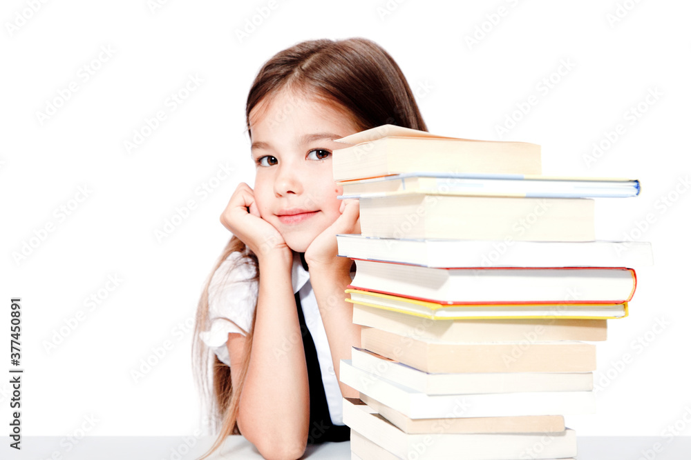 Young cute girl sitting at the table and reading a book Young cute girl sitting at the table and reading a book