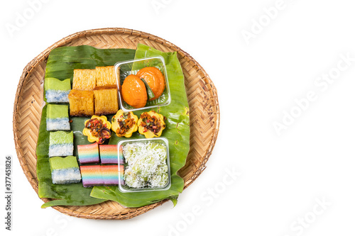 Photography Overhead view of assorted nyonya kueh on banana leaf rattan tray