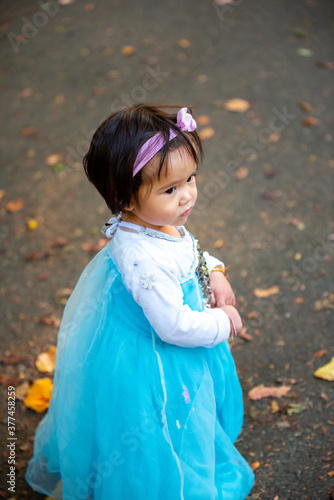 girl in the autumn park on blue dress