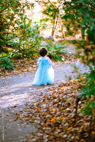 girl in the autumn park on blue dress