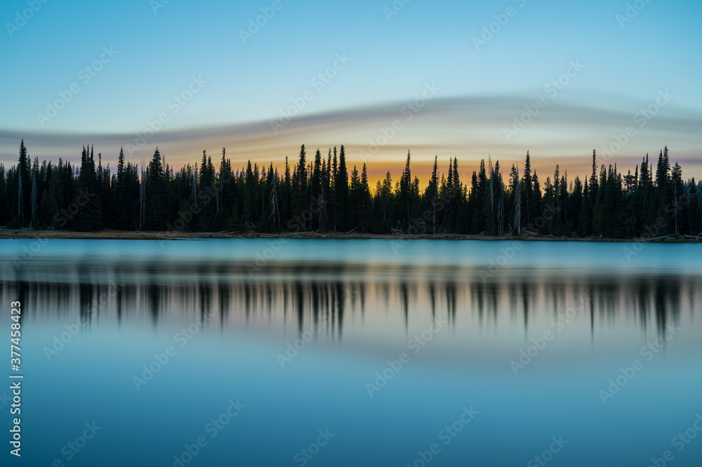 Sunrise at Cascade lake in Oregon during 2020 fire season with orange sky Sunrise at Cascade lake in Oregon during 2020 fire season with orange sky
