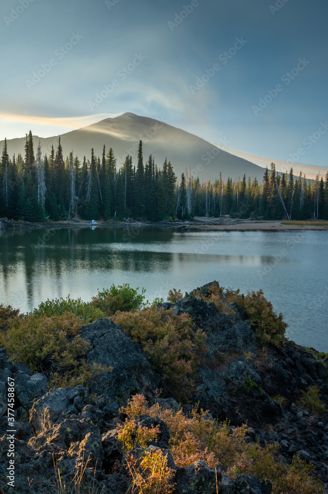 Smoke from distant wildfires 2020 surround Mt. Bachelor in Oregon. Tent at shoreline.