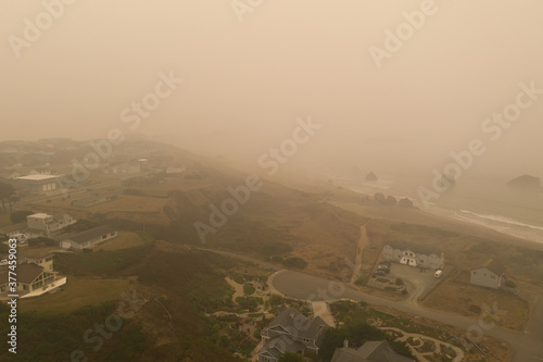 Aerial of Bandon Oregon during wildfire season 2020 with brown ash filled air