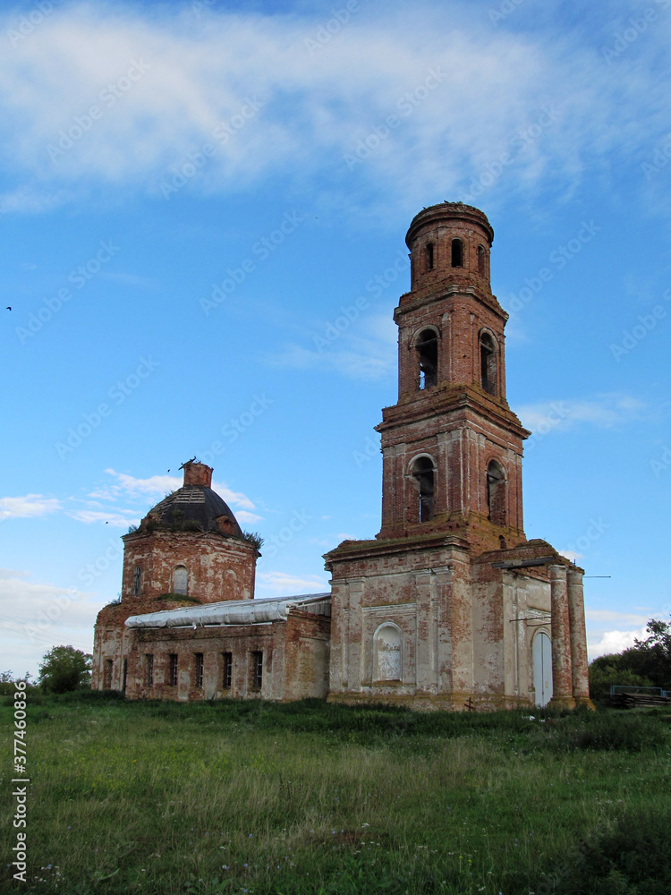 An old abandoned Church against a blue sky with clouds