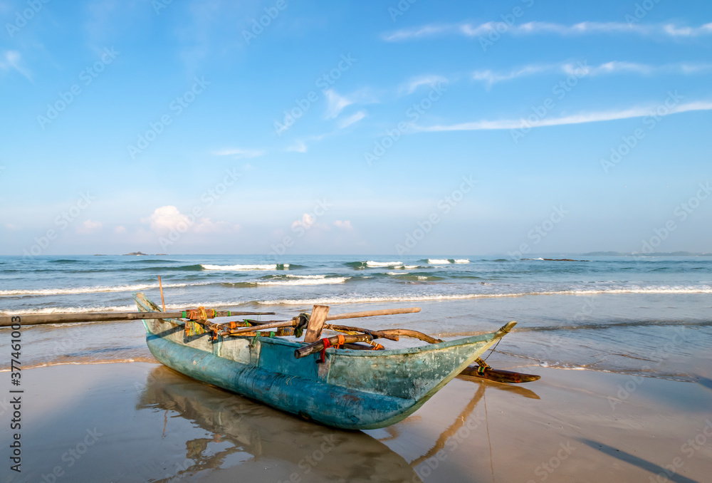 Wooden fishing boat on the shore of the Indian ocean on the island of Sri Lanka