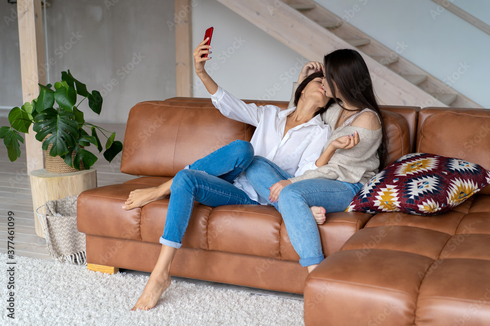 Obraz premium beautiful LGBT couple take selfies and talk via video link. High quality photo