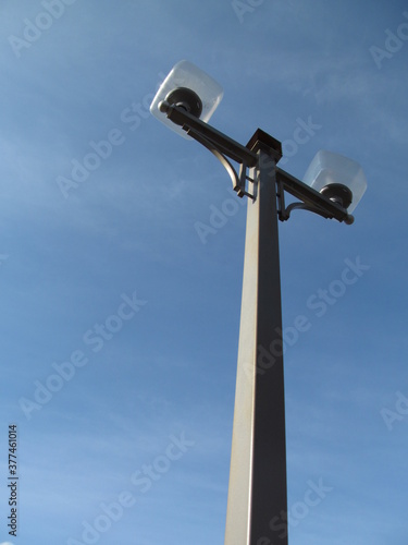 Lamp post with square diffusers on blue sky