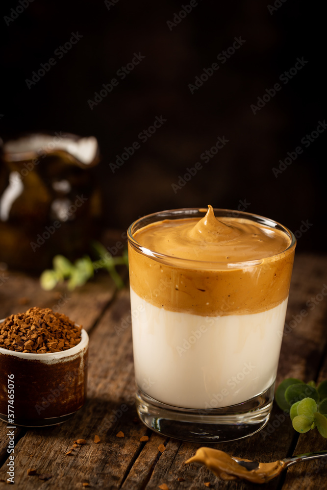 Dalgona Coffee, a cool fluffy whipped coffee in a glass. Latte espresso with coffee foam in tall glass. Trendy drink Dalgona Coffee, a cool fluffy whipped coffee in a glass. Latte espresso with coffee foam in tall glass. Trendy drink