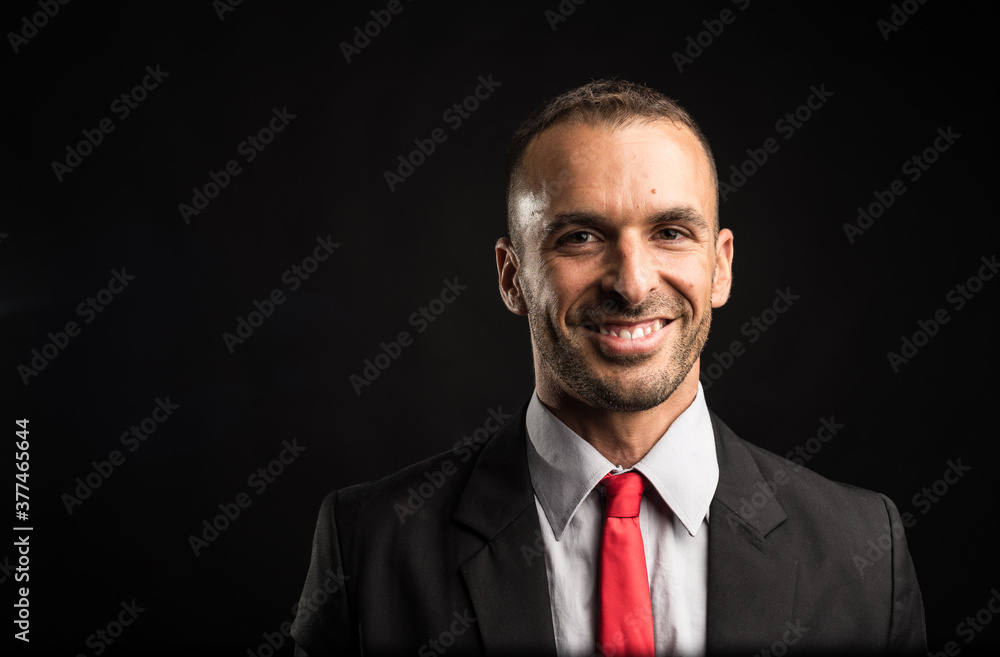 Handsome and smiling man in suit. Close up. Black background. Handsome and smiling man in suit. Close up. Black background.