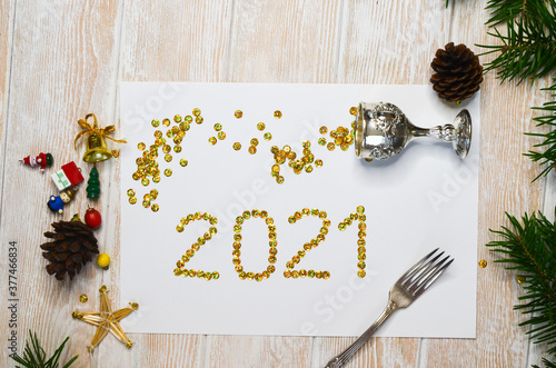 celebrate 2021 new year holiday background silver glass with gold confetti no people