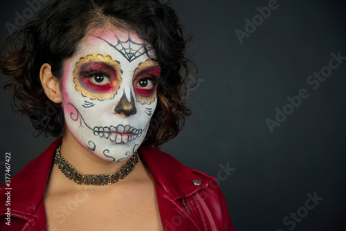mujer joven latina mexicana maquillaje catrina calavera día de muertos chaqueta roja cabello corto aislada close up