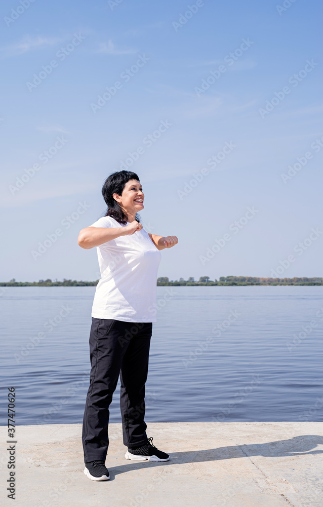 Active and happy senior woman exercising near the riverside Active and happy senior woman exercising near the riverside