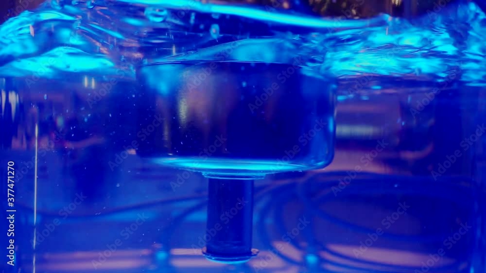submersible float in a transparent glass tube filled with illuminated liquid submersible float in a transparent glass tube filled with illuminated liquid