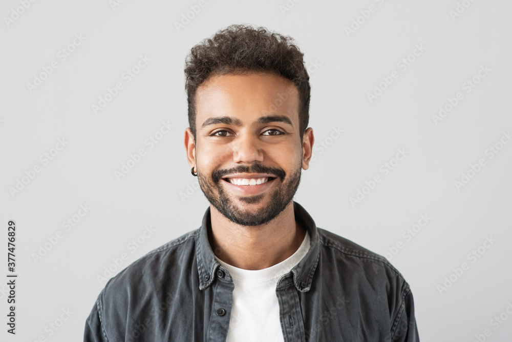 Obraz premium Handsome smiling young man portrait, Laughing joyful cheerful businessman studio shot, Isolated on gray background