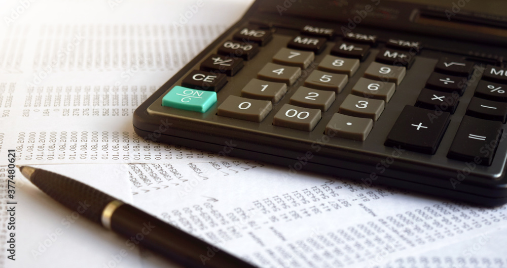 Business documents on an office desk with a calculator and pencil as a business concept of a workspace. With cloud exposure Business documents on an office desk with a calculator and pencil as a business concept of a workspace. With cloud exposure