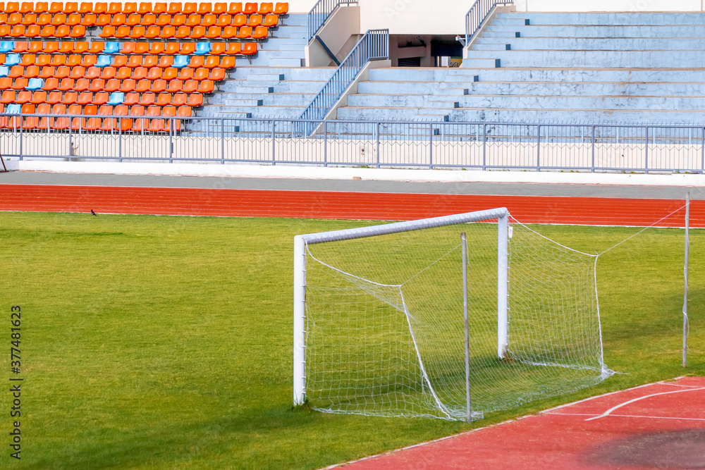 Obraz premium Football goals in a stadium with fresh green grass 