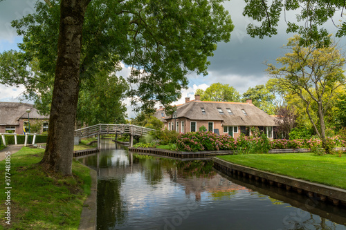 House with hydrangeas in the garden at the canal in Giethoorn