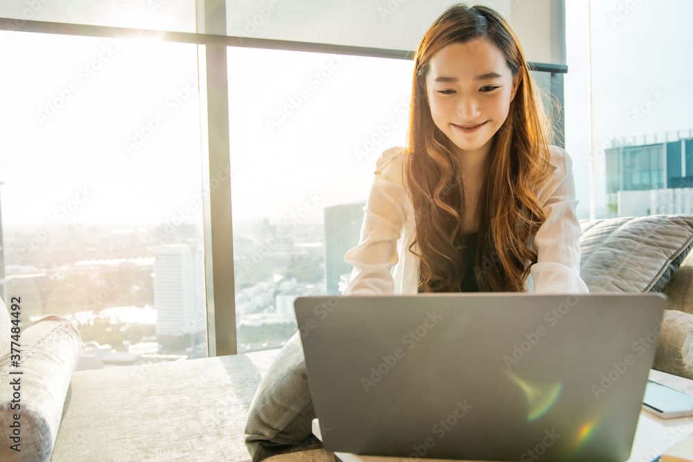 Asian young woman working laptop. Business woman busy typing on laptop computer at office in the city. Asian young woman working laptop. Business woman busy typing on laptop computer at office in the city.