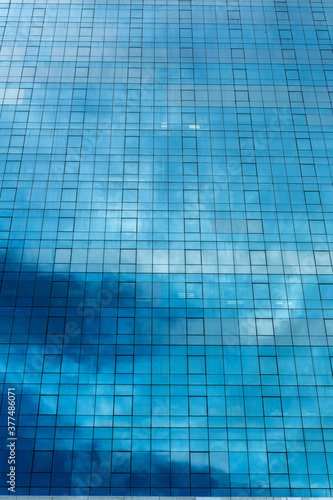 blue glass wall of skyscraper
