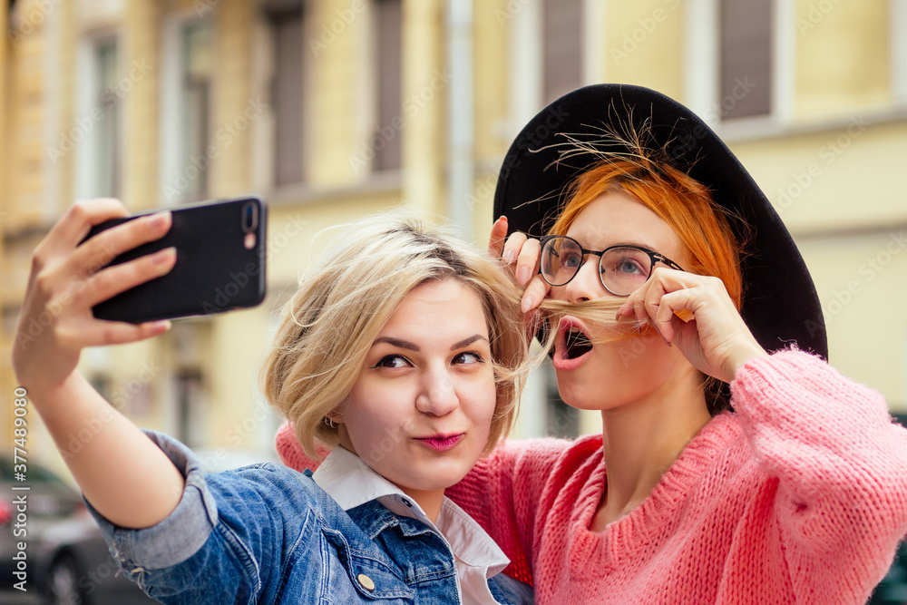happy women using social network app meeting website outdoors in Europe streets making selfie happy women using social network app meeting website outdoors in Europe streets making selfie