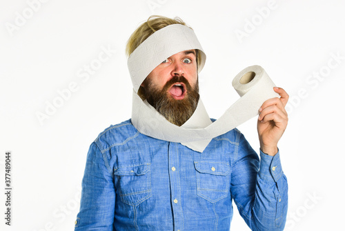 buy toilet paper roll. hipster with stomach issues holding toilet paper. soft and pleasant to your skin. problems in toilet. wc and restroom. concept of sterility and purity. typical morning routine photo