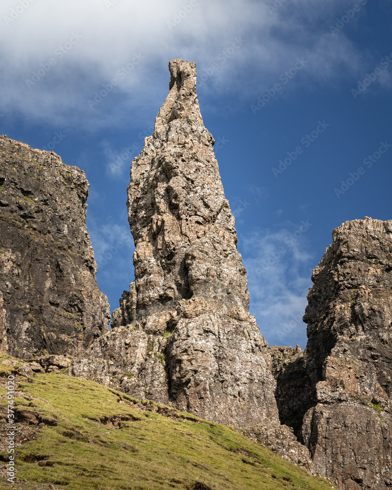 View of the Needle rock formation in Quiraing, Isle of Skye, Scotland. 37-metre pinnacle surrounded by cliffs is part of Trotternish mountain ridge