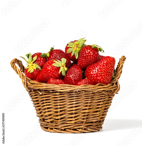 Strawberries and basket isolated on a white background.