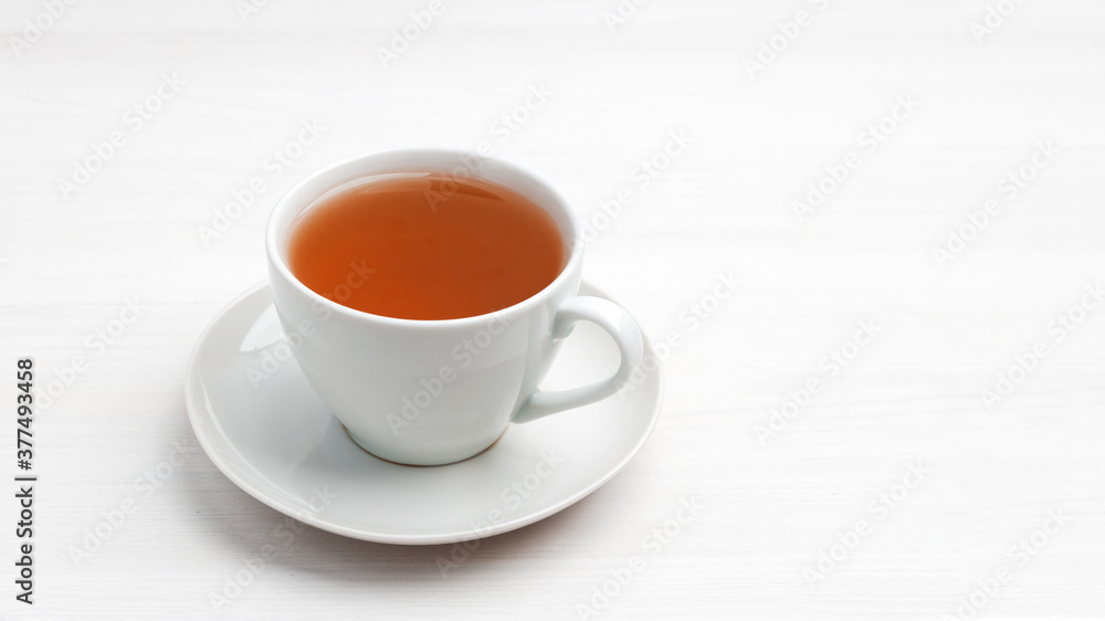 White cup of tea on a white wooden table. Copyspace. White cup of tea on a white wooden table. Copyspace.