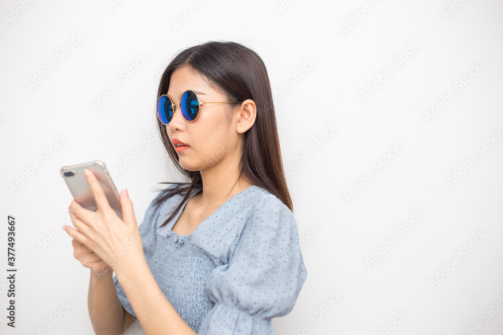 Beautiful fashion asian sunglasses women use smartphone