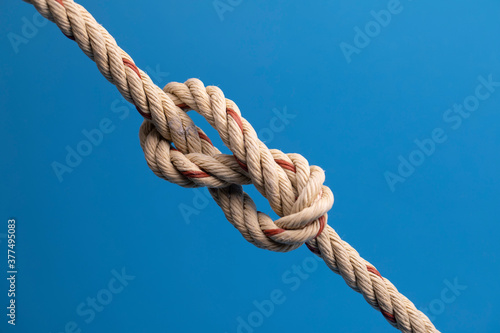 Rope with a knot on blue background
