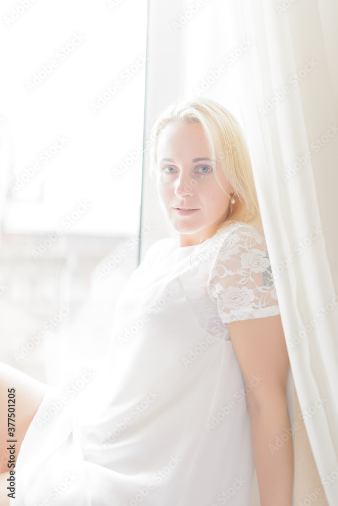 Beautiful lady sitting by the window Beautiful lady sitting by the window