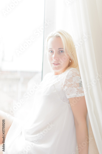 Beautiful lady sitting by the window