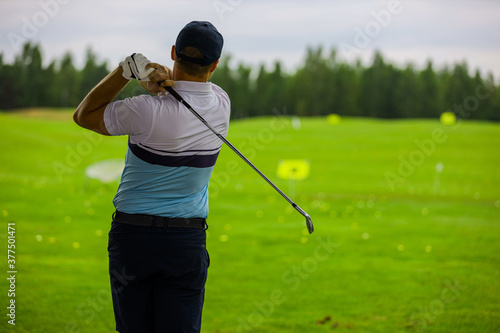 Golfer playing with club on the field