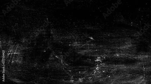 Abstract black background with white spots on old shabby black surface 