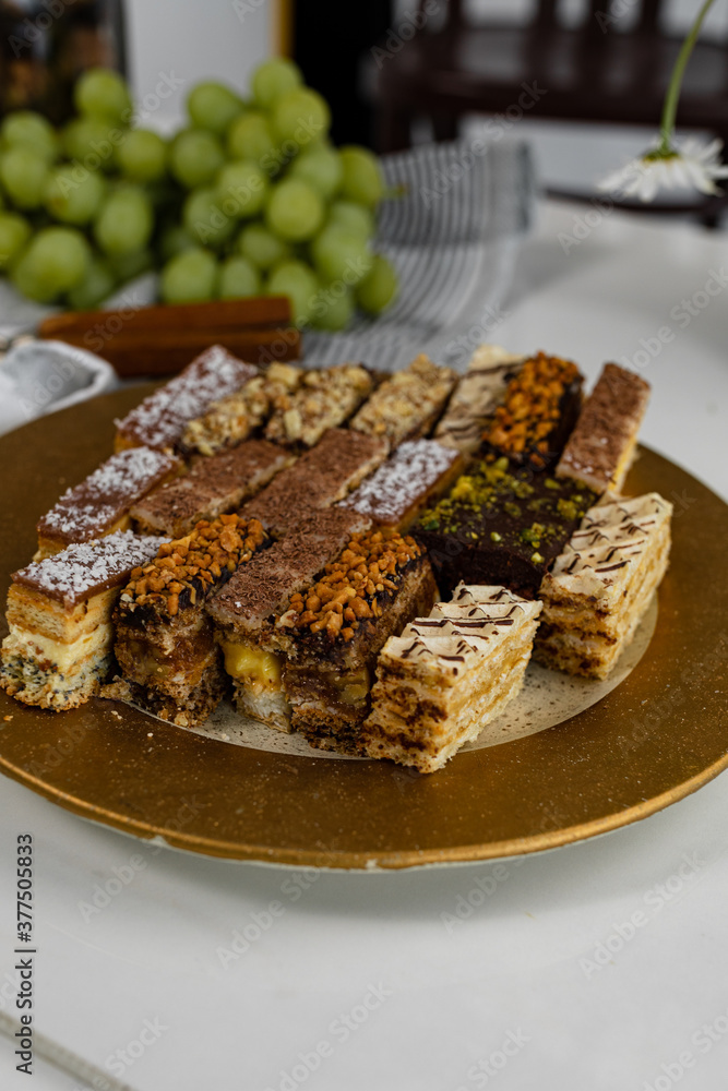 Assorted homemade cakes stage with grapes and nuts.