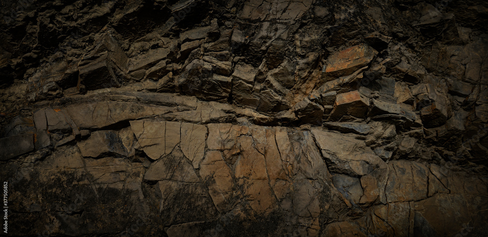 Dark grunge background. Stone background. Brown rock texture. Close-up. Rusty background. Dark grunge background. Stone background. Brown rock texture. Close-up. Rusty background.