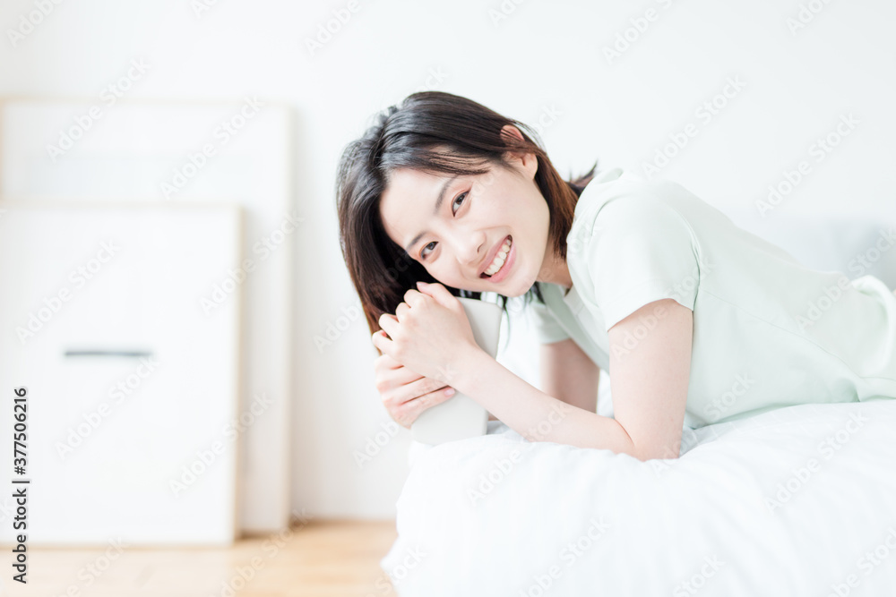 Asian woman using mobile phone indoors Asian woman using mobile phone indoors