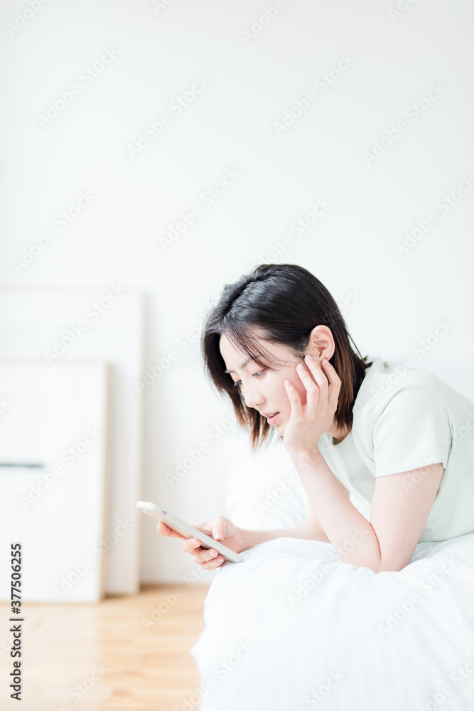 Asian woman using mobile phone indoors Asian woman using mobile phone indoors