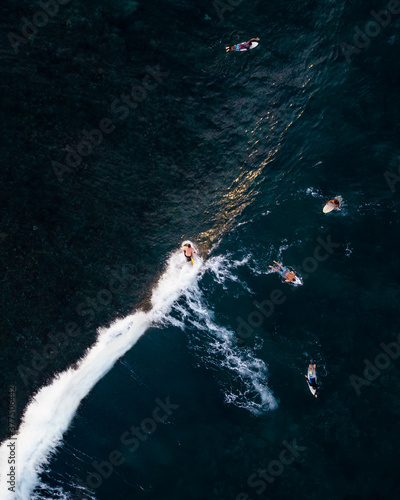 Aerial photo of a man surfing in Siargao island, Philippines. © Jonathan