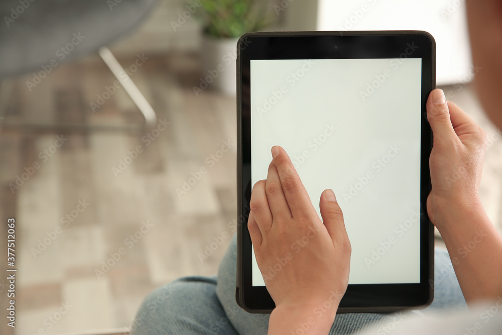 Woman working with modern tablet indoors, closeup. Space for design