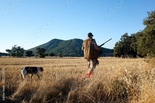Hunter with dog at field